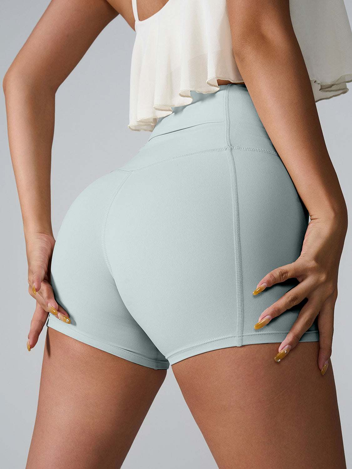 High Waist Active Shorts with pockets, stretchy nylon-spandex blend, in light gray color.