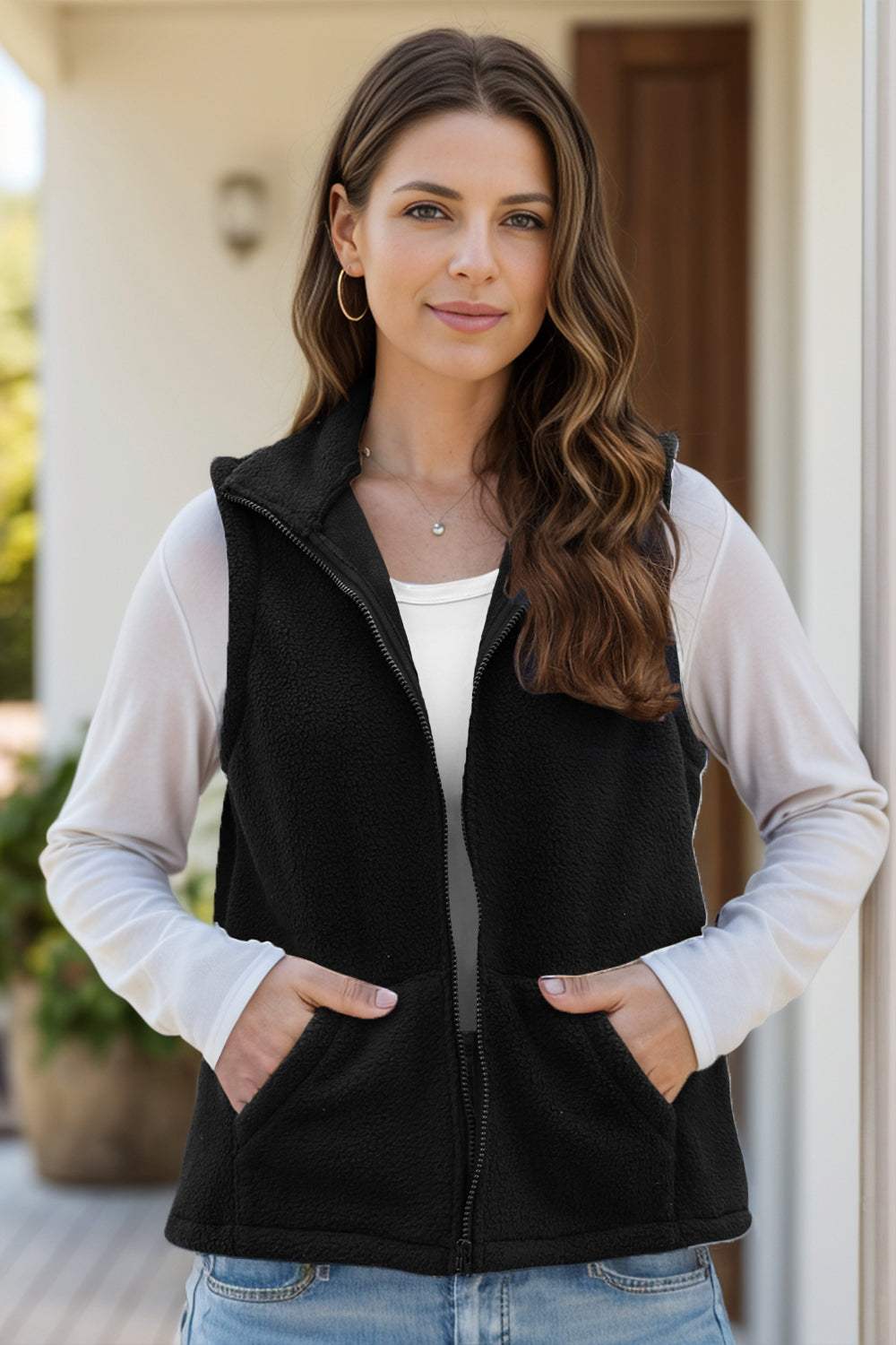 Women's zip up vest coat with pockets, black, made of polyester and spandex.