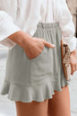 Full Size Ruffled Elastic Waist Shorts in light fabric with side pockets and a feminine ruffled hem.