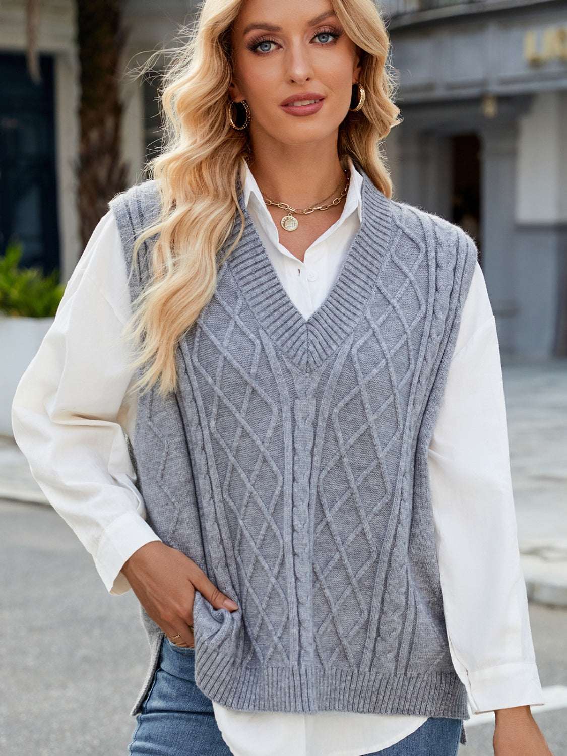 Cable knit v-neck sweater vest in grey with white shirt underneath.