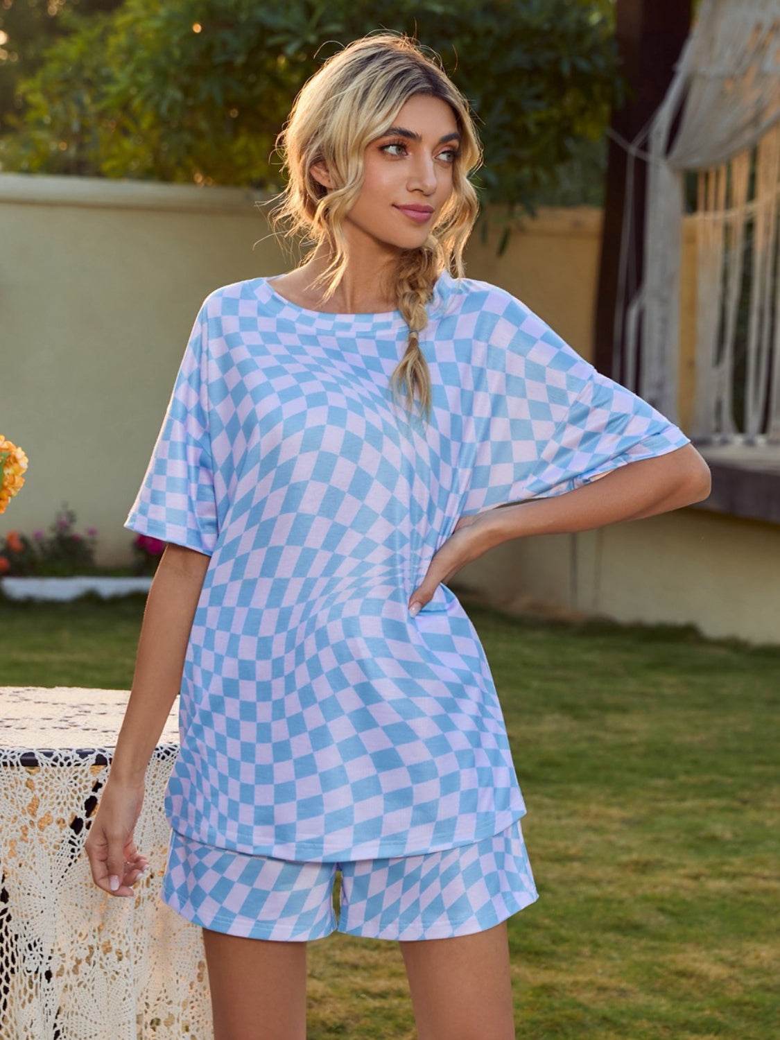 Plaid round neck top and shorts lounge set in pastel colors, modeled outdoors.