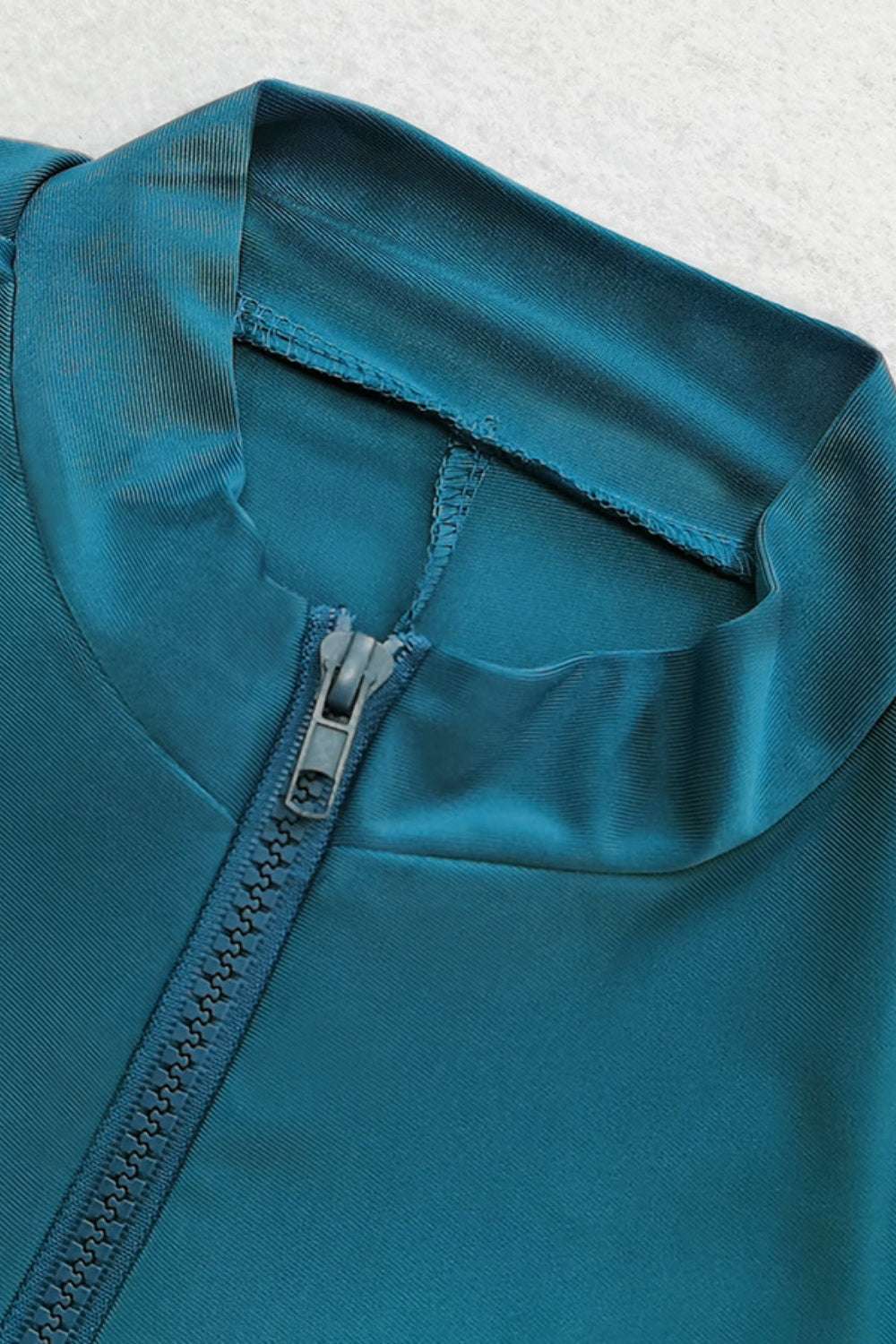 Teal quarter zip top detail from the Cap, Quarter Zip Top and Pants Swim Set.