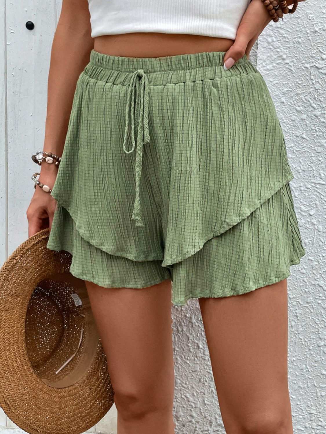 Perfee Tied Layered High Waist Shorts in green, featuring a ruffled design, opaque polyester fabric.