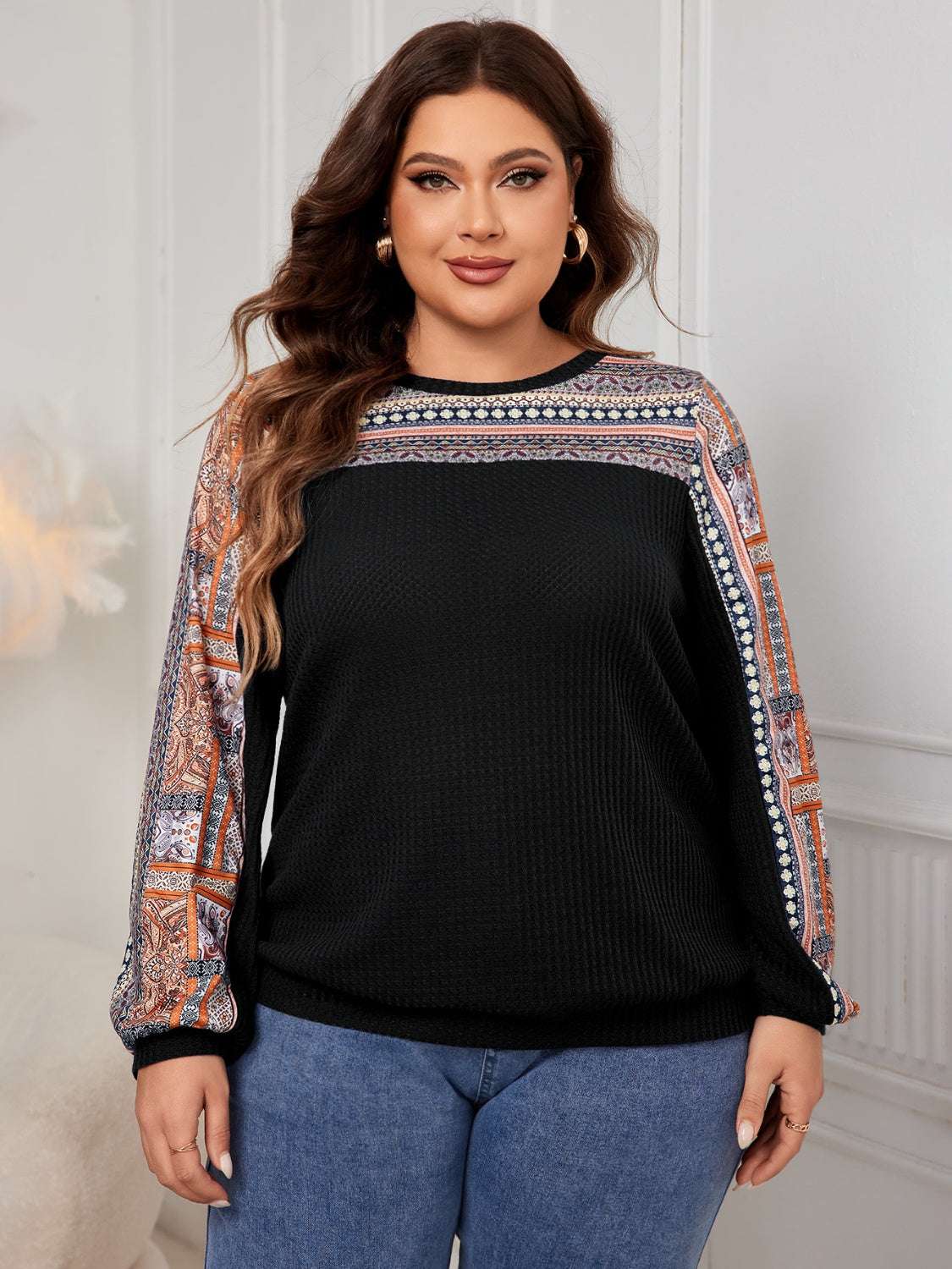 Plus size printed long sleeve sweatshirt in black with colorful patterned details, slightly stretchy fabric.