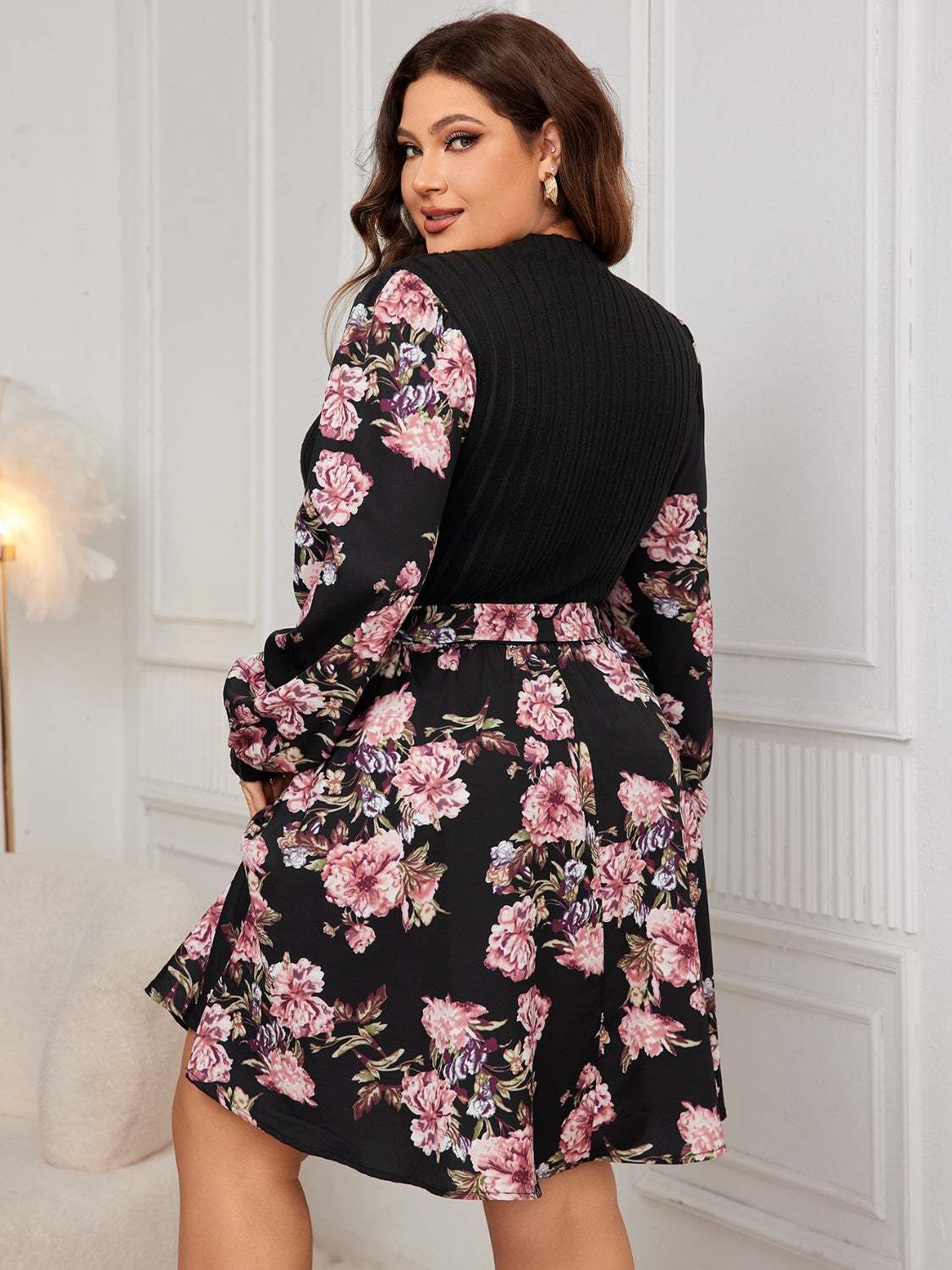 Plus size floral printed long sleeve dress with tied waist and slight stretch.