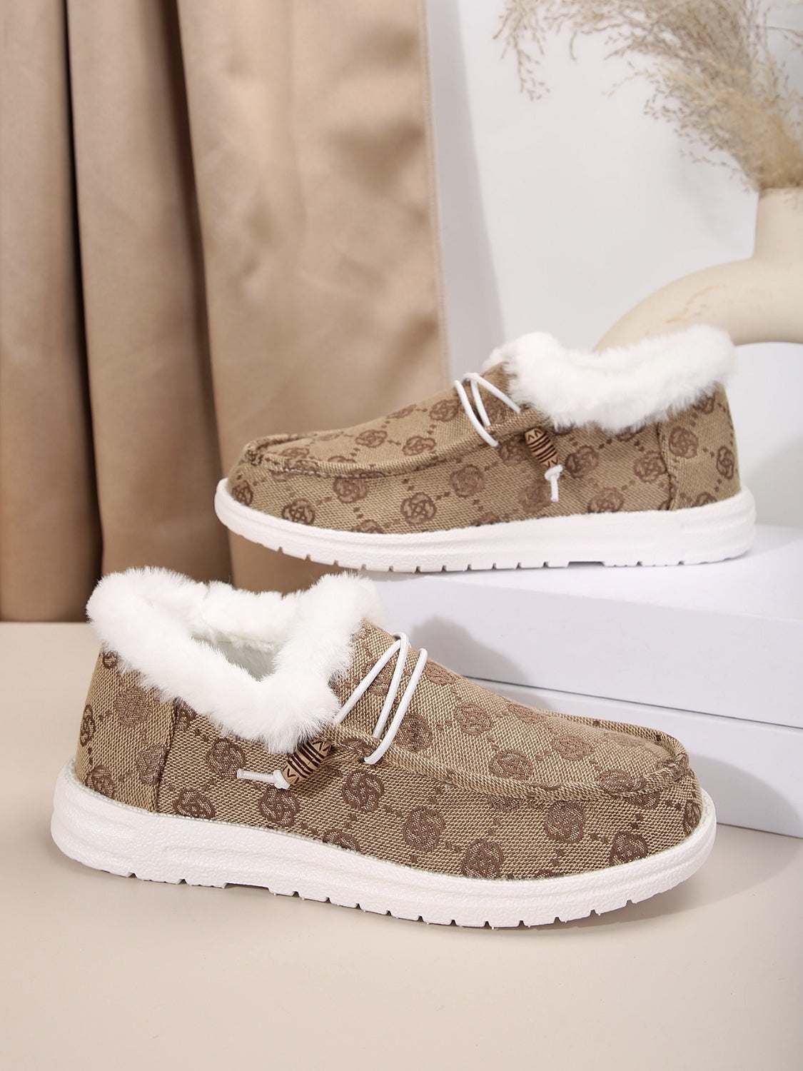 Printed round toe flat slip-ons with faux fur lining and white soles.