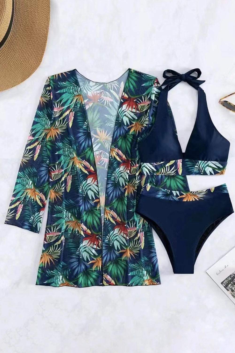 Printed halter neck three-piece swim set with vibrant tropical design.