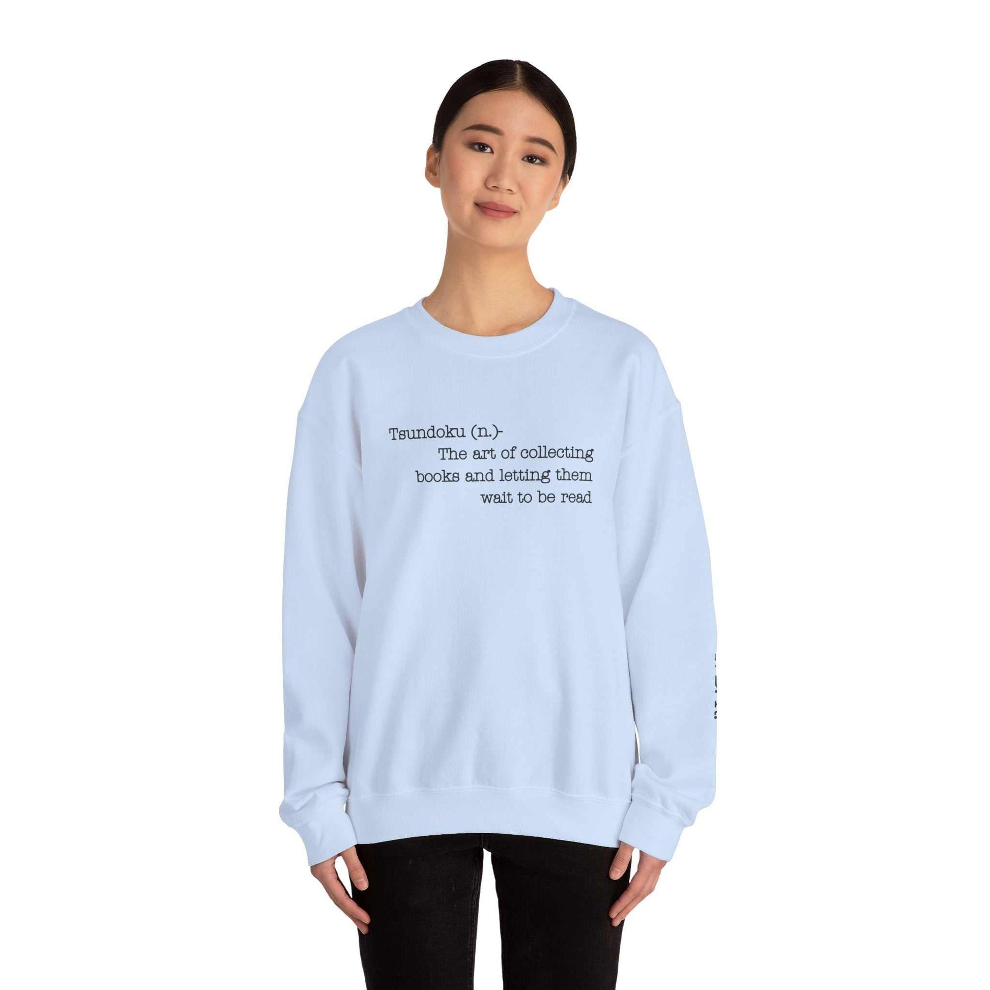 "T. B. R. Tsundoku" crewneck sweatshirt with definition of "Tsundoku" on front, ideal for book enthusiasts.