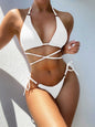 Textured halter neck tie side bikini set in solid color with crisscross design.