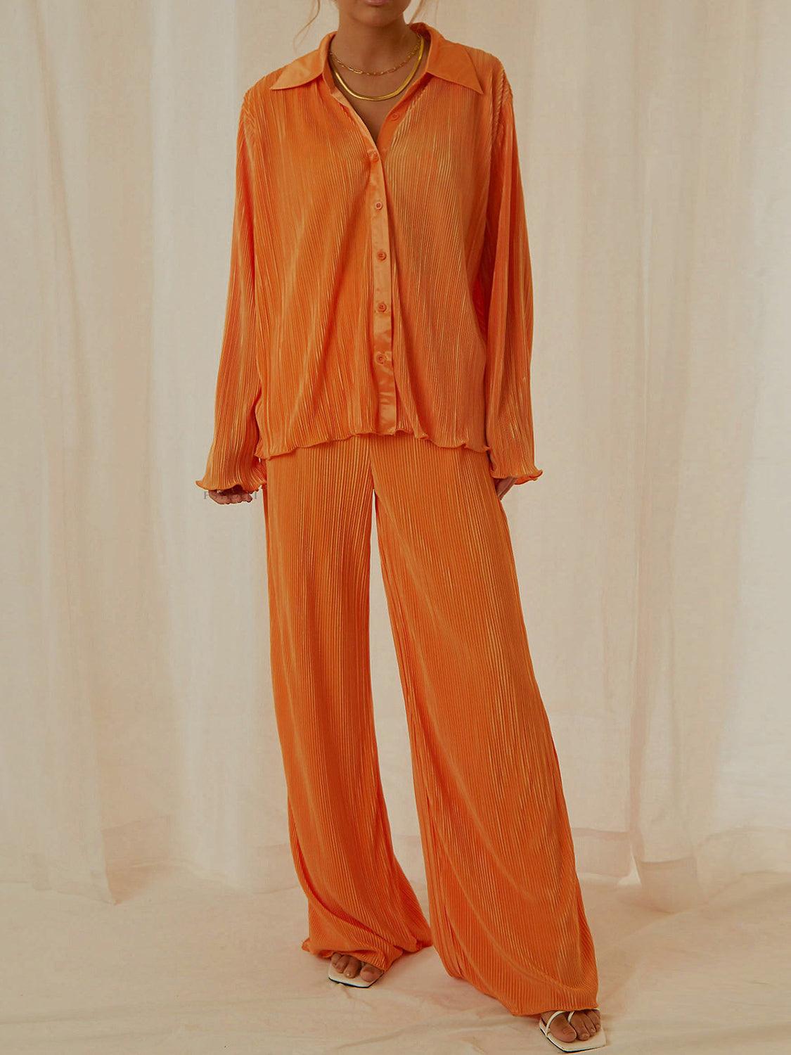 Collared neck long sleeve top and pants lounge set in orange polyester, buttoned two-piece outfit.