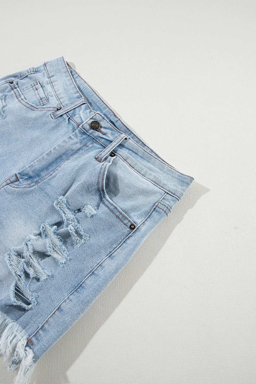 Distressed raw hem denim shorts with slightly stretchy fabric.