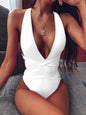 Halter neck deep V tied one-piece swimsuit with crisscross detail in solid white.