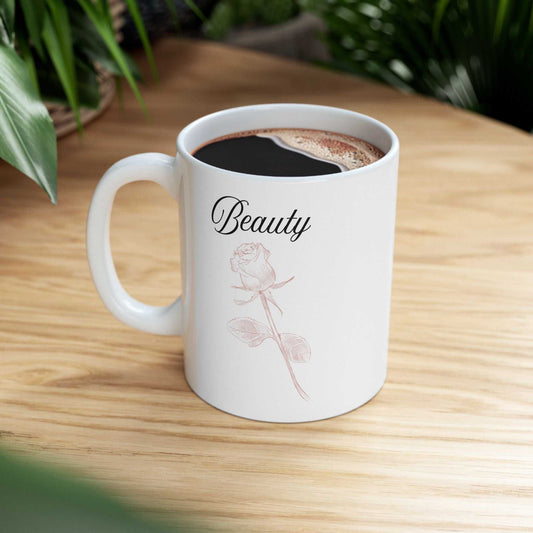 Ceramic mug with "Beauty" text and dusty rose design, ideal for gifts and hot beverages.