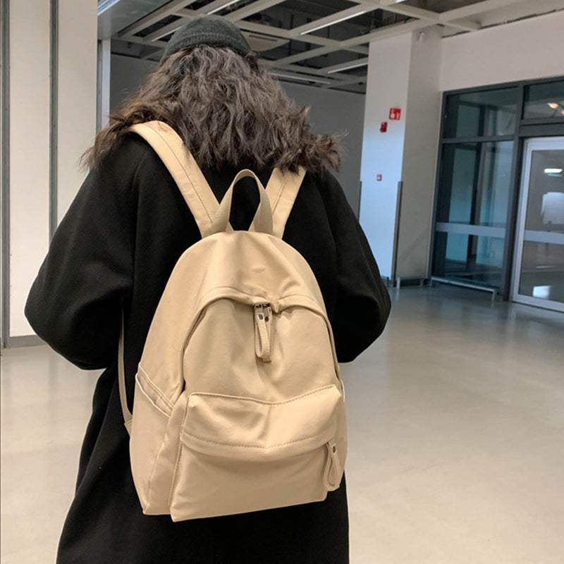 Large zip cotton backpack bag worn by person indoors.