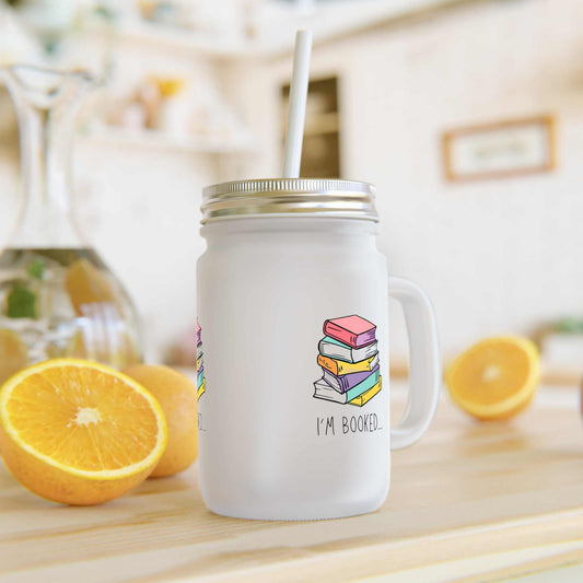 Mason jar mug with stack of books graphic and "I'm Booked" text on frosted glass.