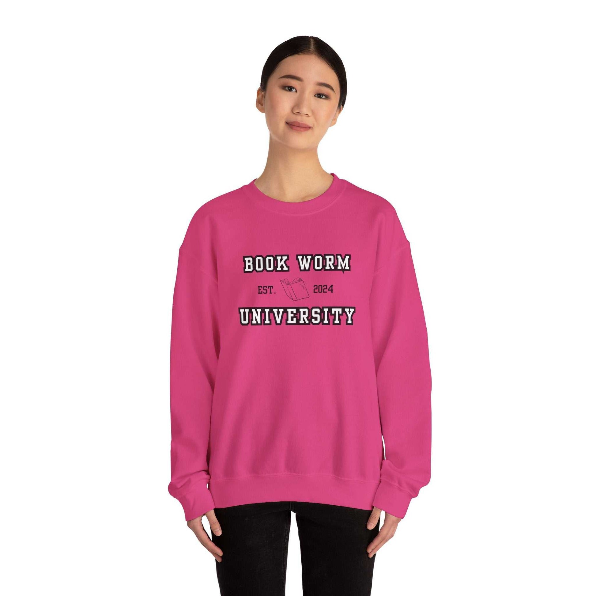 Bookworm University crewneck sweatshirt with 'Est 2024' design in pink, worn by a model.