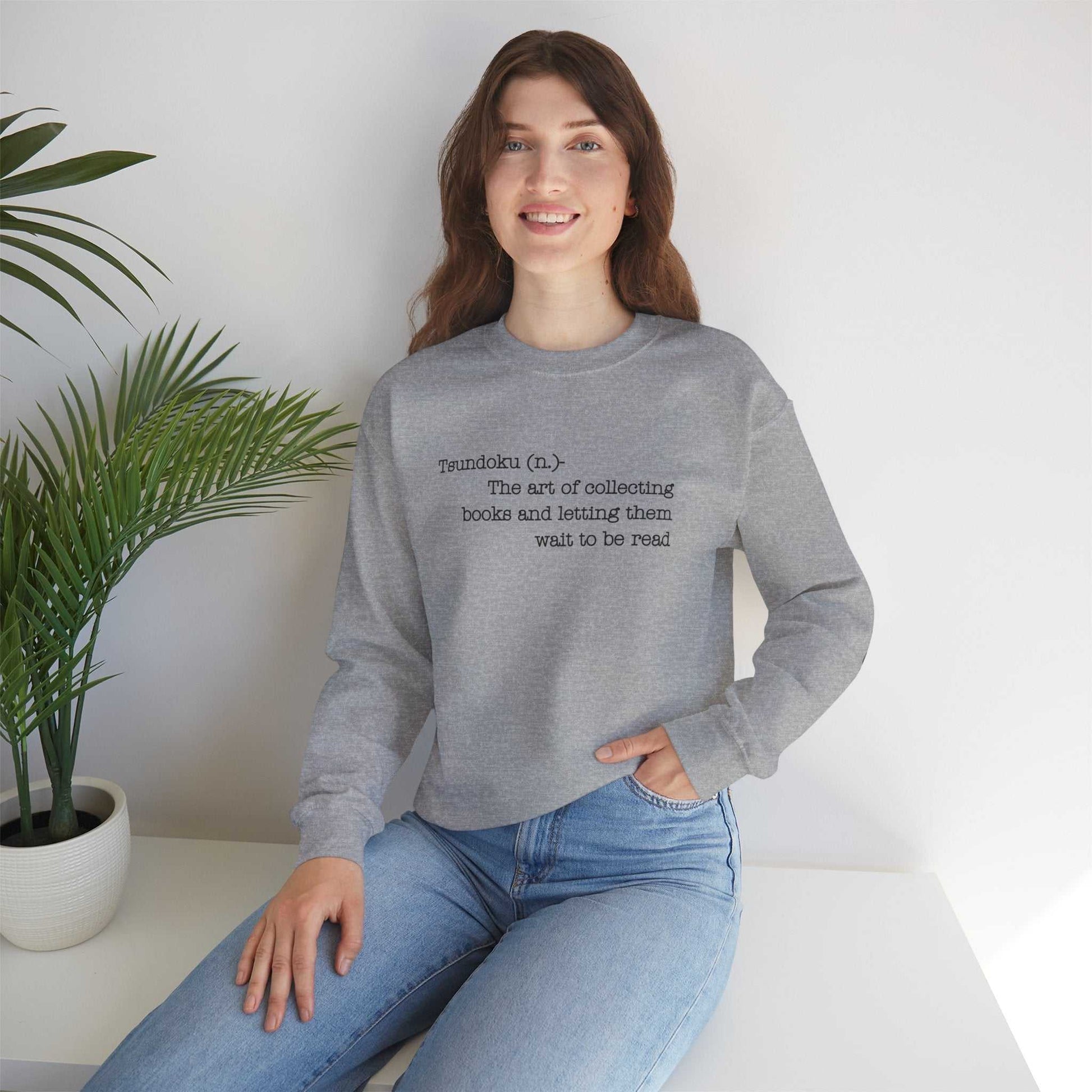 Gray crewneck sweatshirt with Tsundoku definition for book lovers.