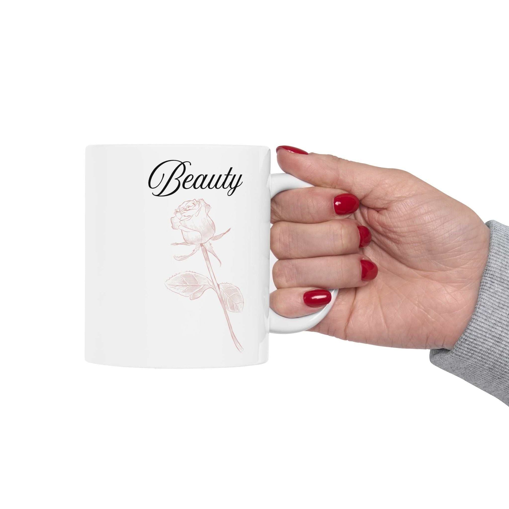 Ceramic mug with 'Beauty' and dusty rose design.