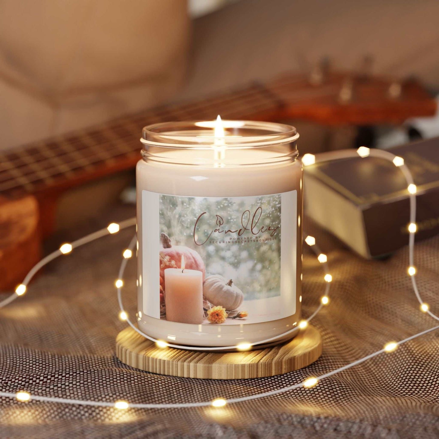 Scented soy candle in glass vessel from Securing Secrets Boutique LLC, surrounded by cozy decor.