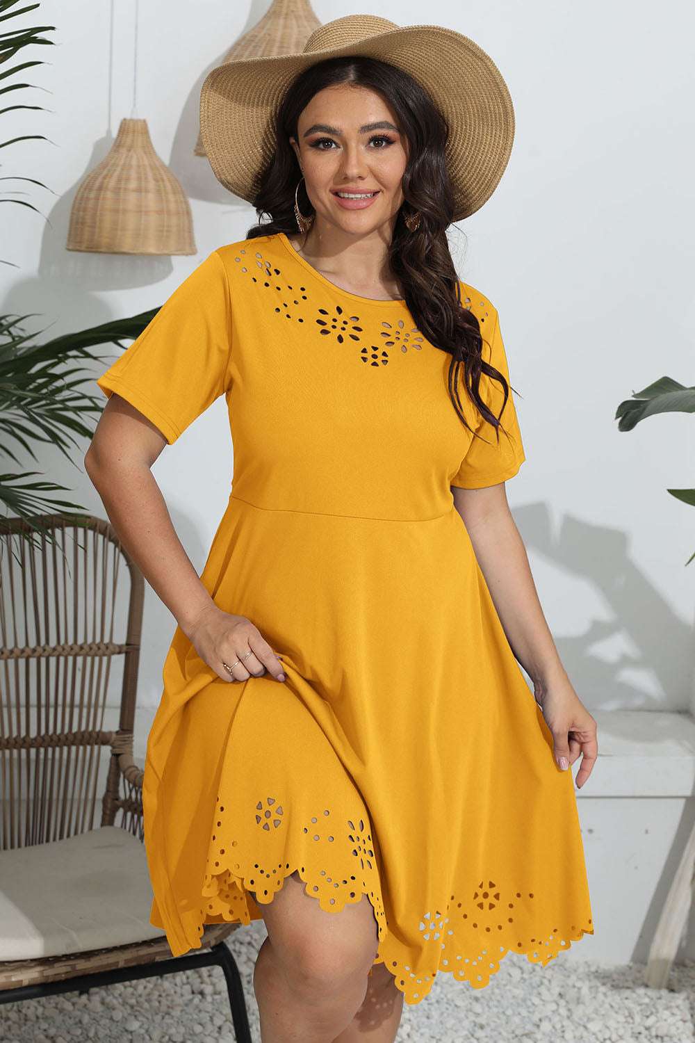 Plus size yellow round neck openwork dress with floral cutouts.