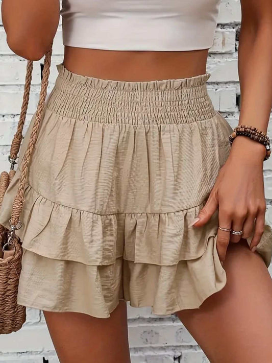 Smocked layered shorts with ruffled design, 100% polyester, casual summer style.