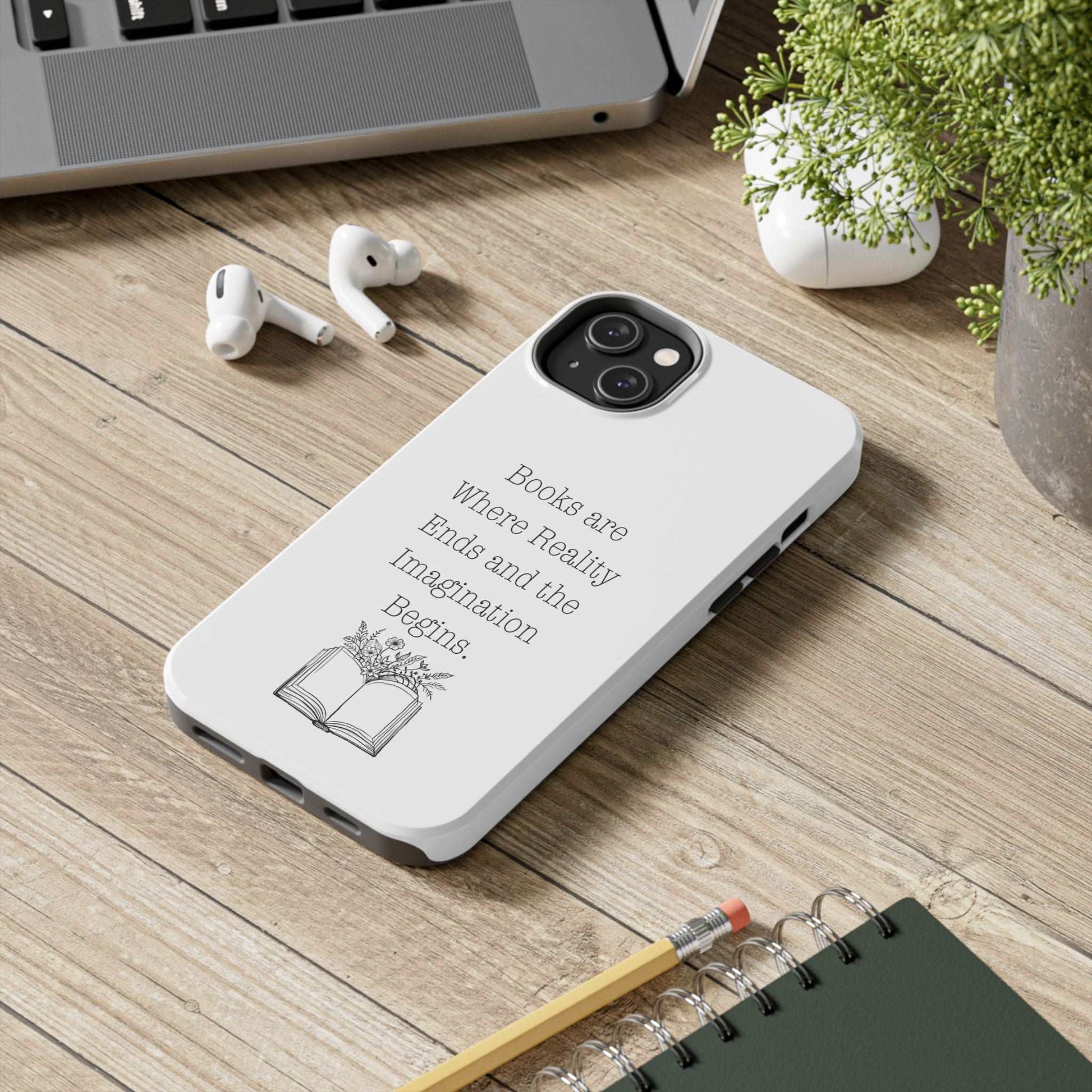 Quote Book Phone Case with flower and book graphic on desk.