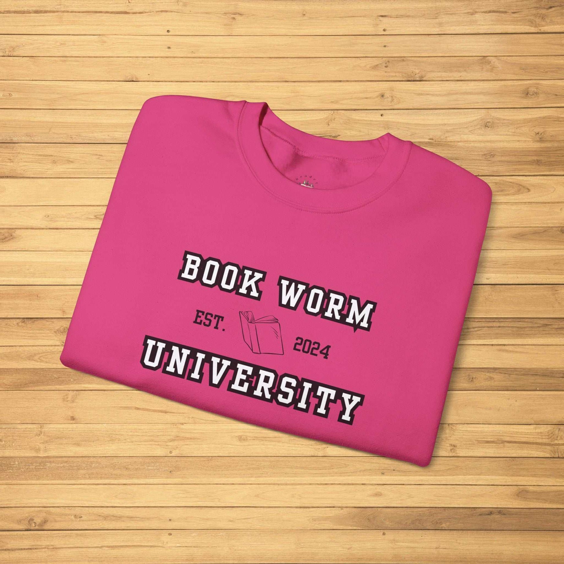 Bookworm University Crewneck Sweatshirt with Est 2024 Design on pink fabric, featuring a book graphic.