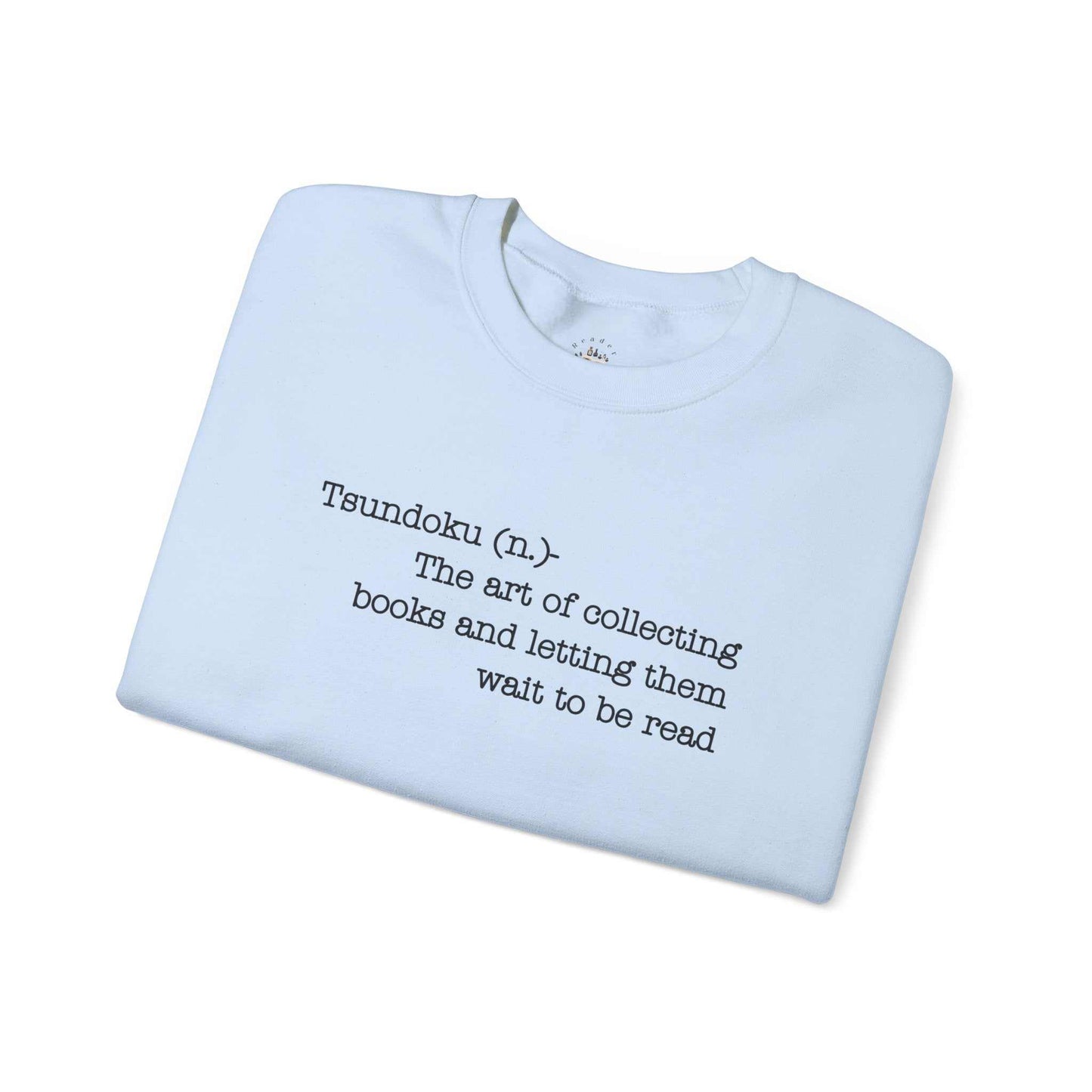 "Tsundoku" crewneck sweatshirt with book collecting definition.