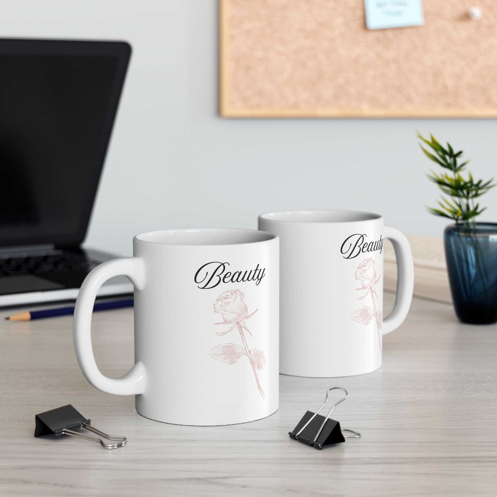 Ceramic mug with 'Beauty' text and dusty rose design, perfect for hot beverages.