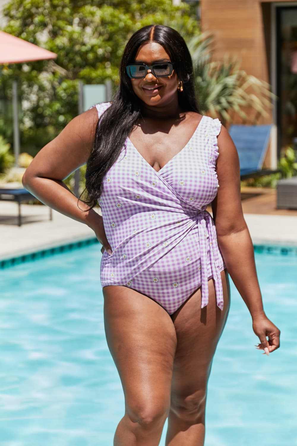 Marina West Swim full-size float on ruffle faux wrap one-piece swimsuit in carnation pink, featuring a plaid and floral pattern.