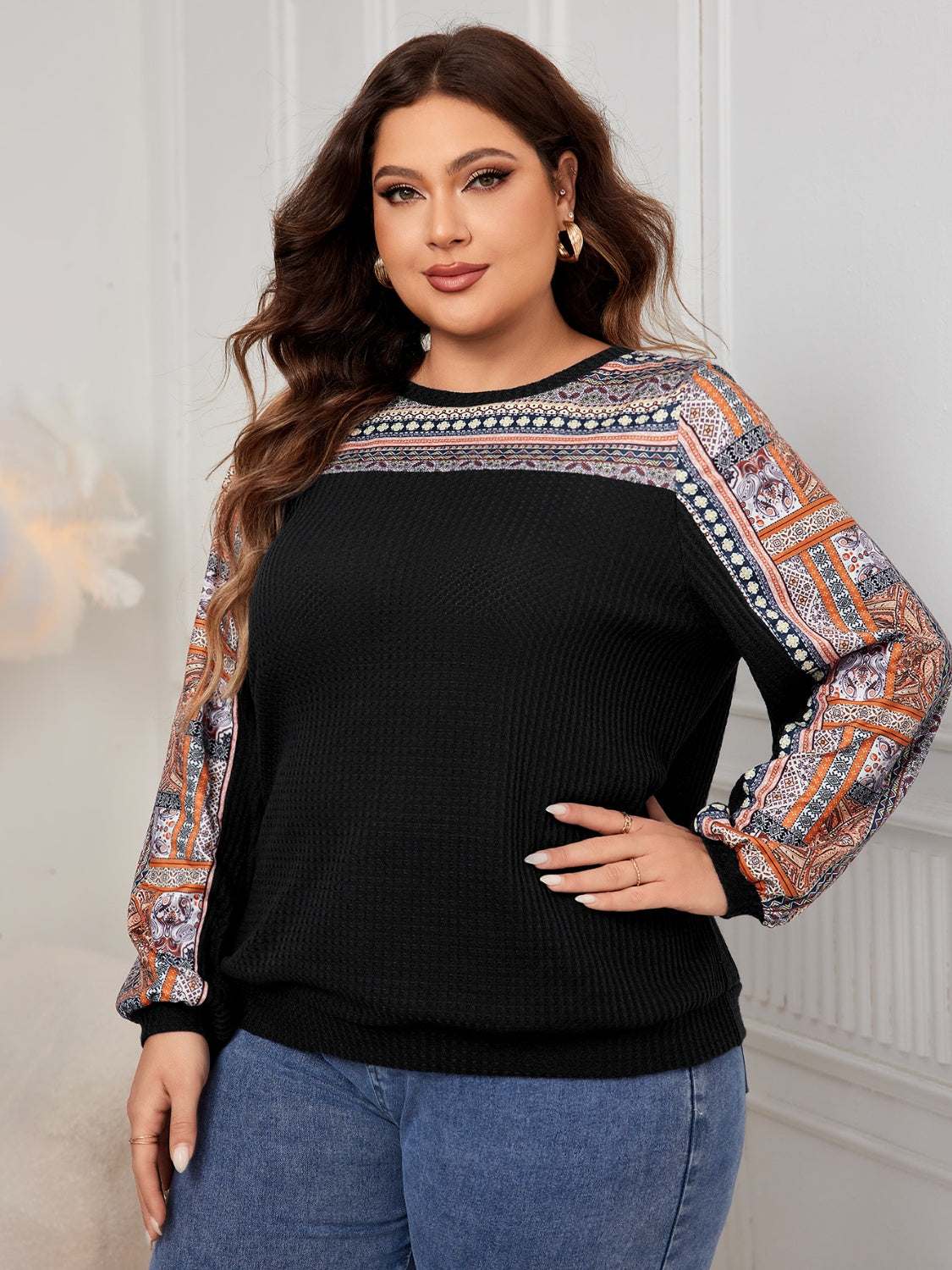 Plus size printed long sleeve sweatshirt in black with patterned sleeves.