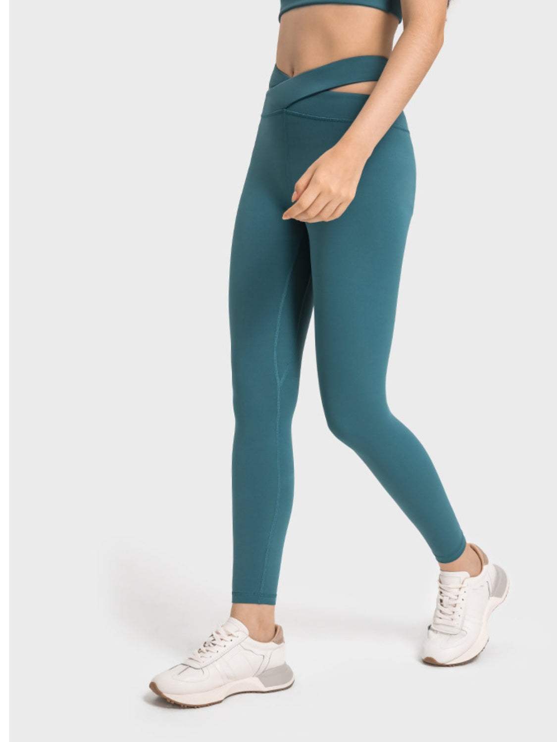 Millennia Crisscross Cutout Sports Leggings in teal with stretchy nylon-spandex fabric.