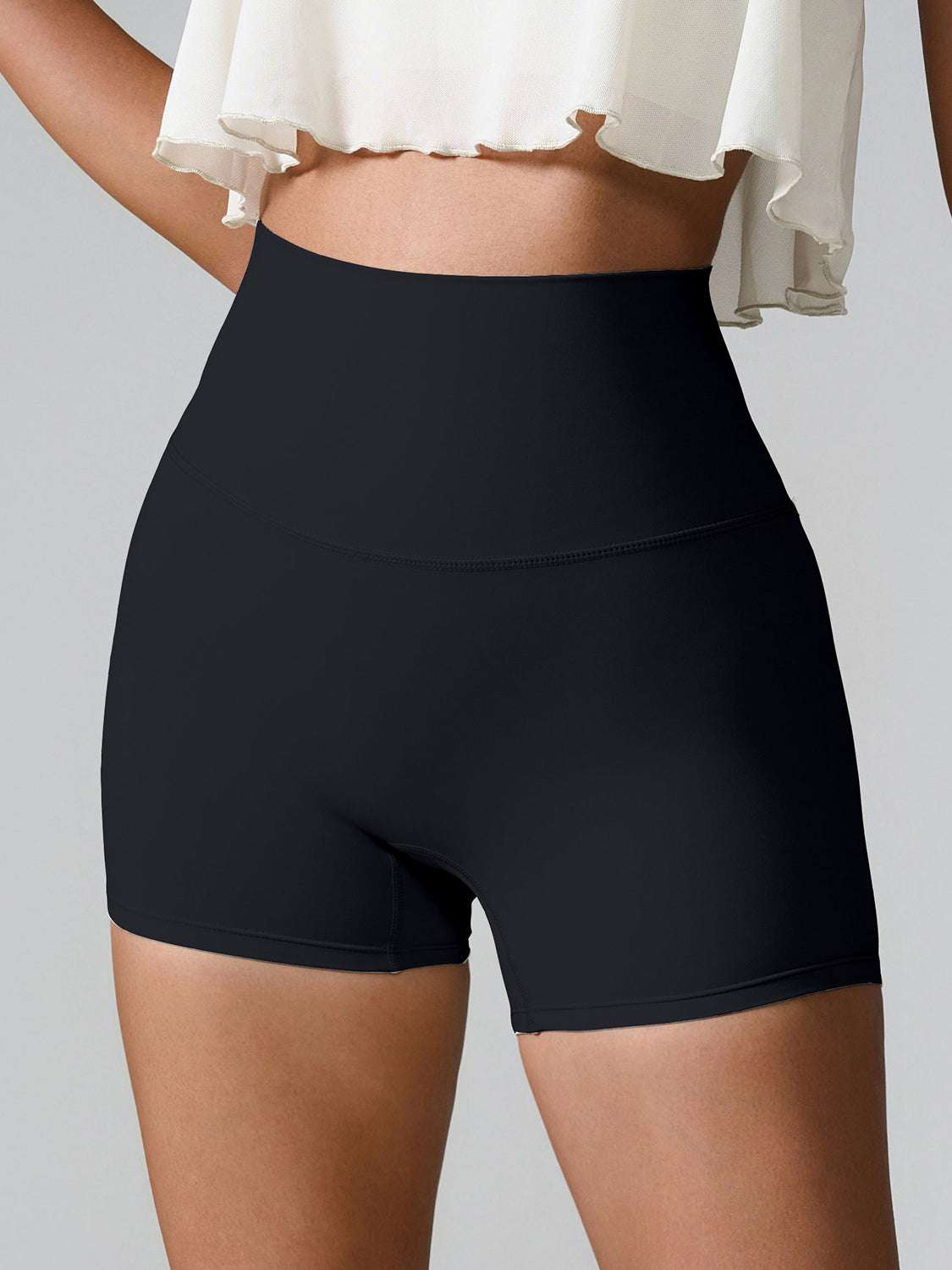 High waist active shorts with pockets, stretchy nylon-spandex blend, black color.