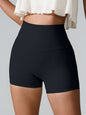 High waist active shorts with pockets, stretchy nylon-spandex blend, black color.