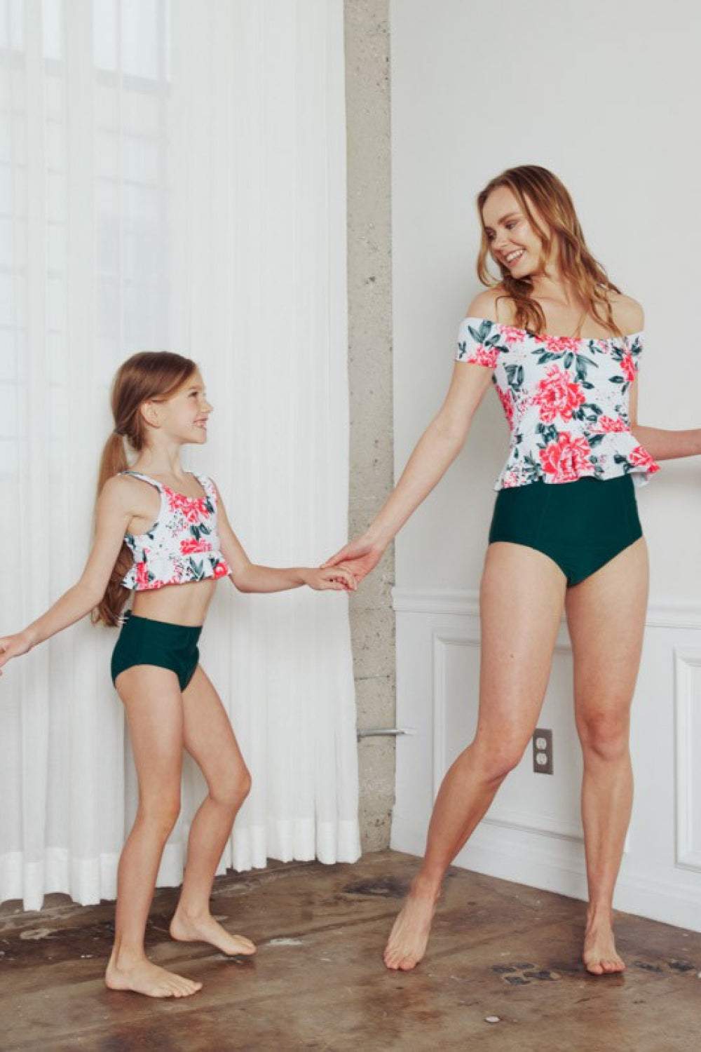 Mother and daughter wearing floral Marina West Swim Coastal Cutie Tankini Swimsuit Sets indoors.