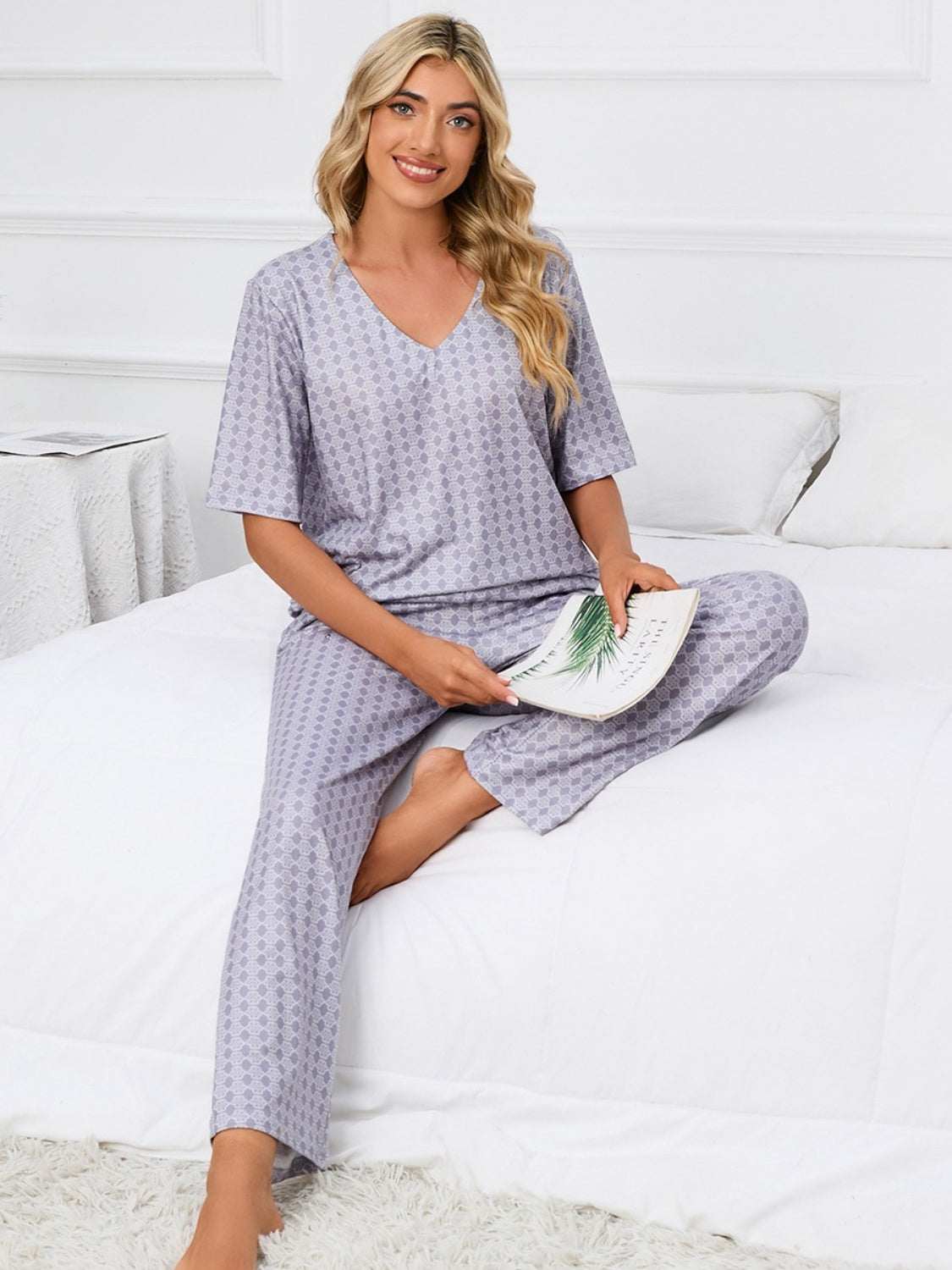 Printed V-Neck Top and Pants Lounge Set in lavender, featuring a comfortable two-piece design with slightly stretchy polyester fabric.