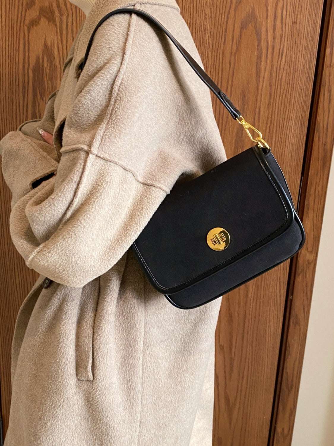 Small PU Leather Suede Twist-Lock Shoulder Bag in black with gold-tone hardware, worn on the shoulder.