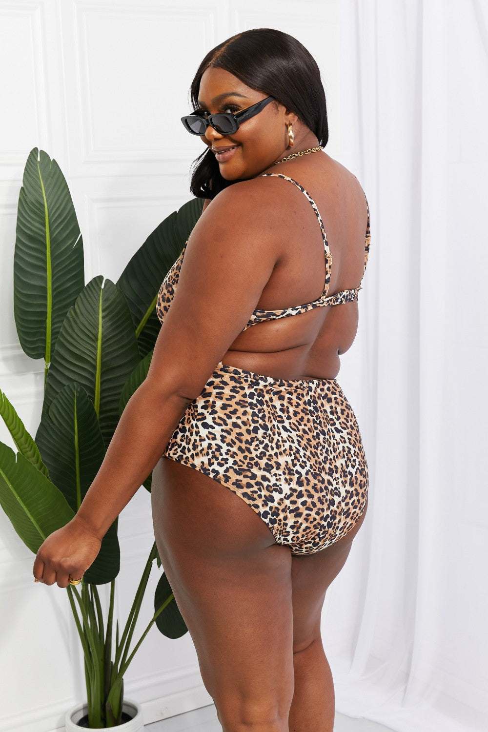 Leopard print cutout one-piece swimsuit with a plunging neckline by Marina West Swim.