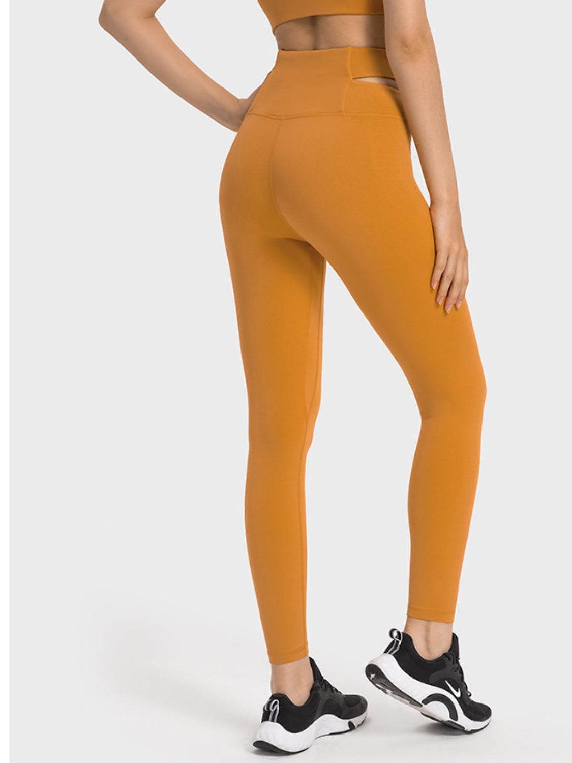 Millennia Crisscross Cutout Sports Leggings in orange, stretchy nylon-spandex blend.