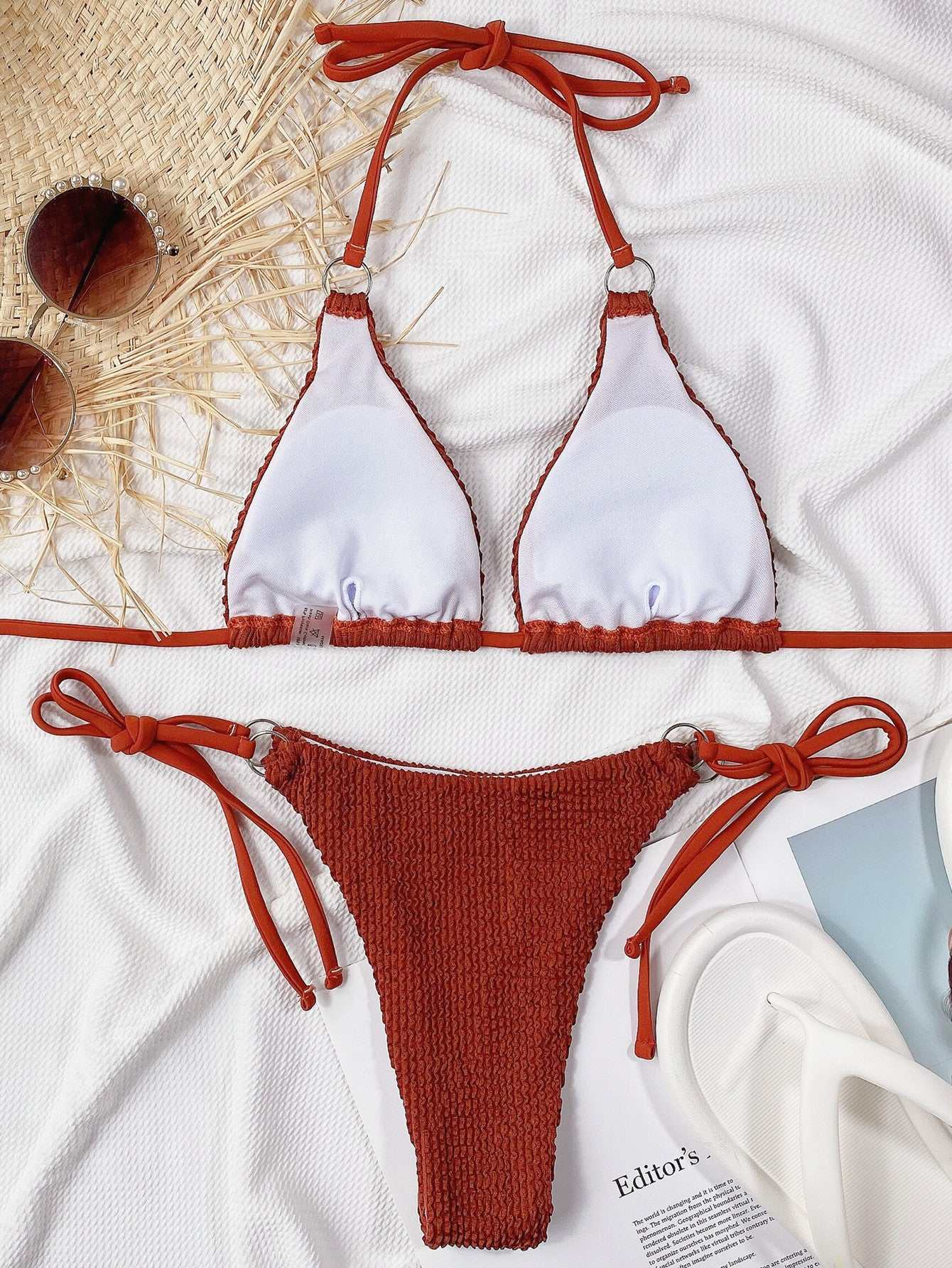 Textured halter neck tie side bikini set in rust color with crisscross straps and removable padding.