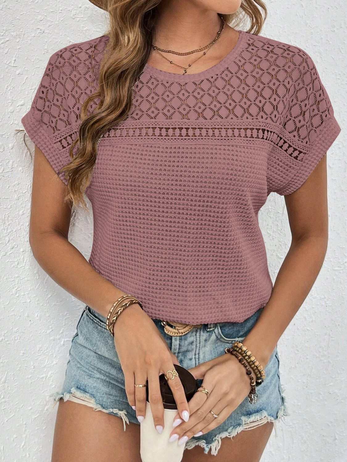 Waffle-knit round neck short sleeve top with lace detail and semi-sheer design.