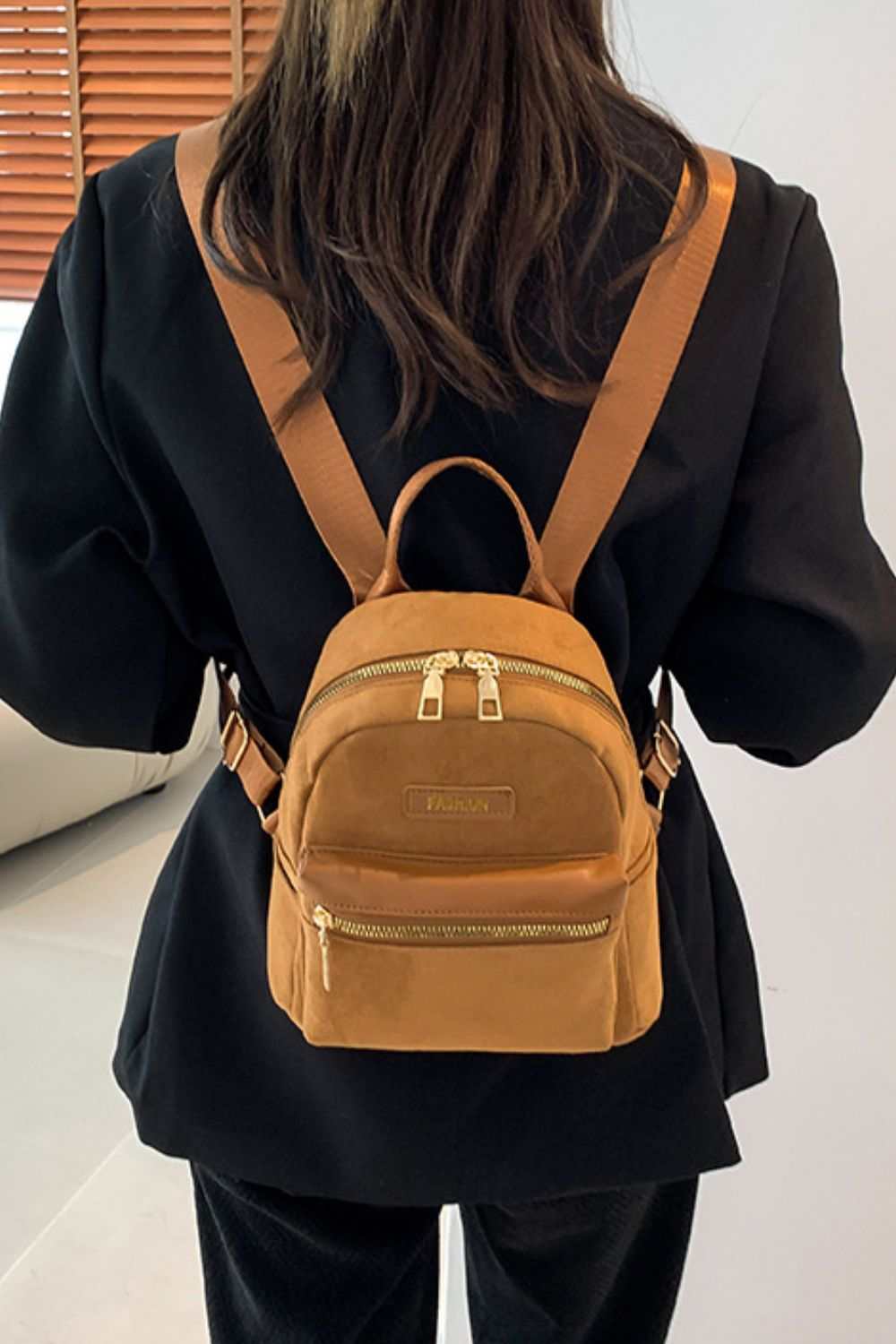 Suede adjustable strap backpack bag, small size, brown color, worn by model.