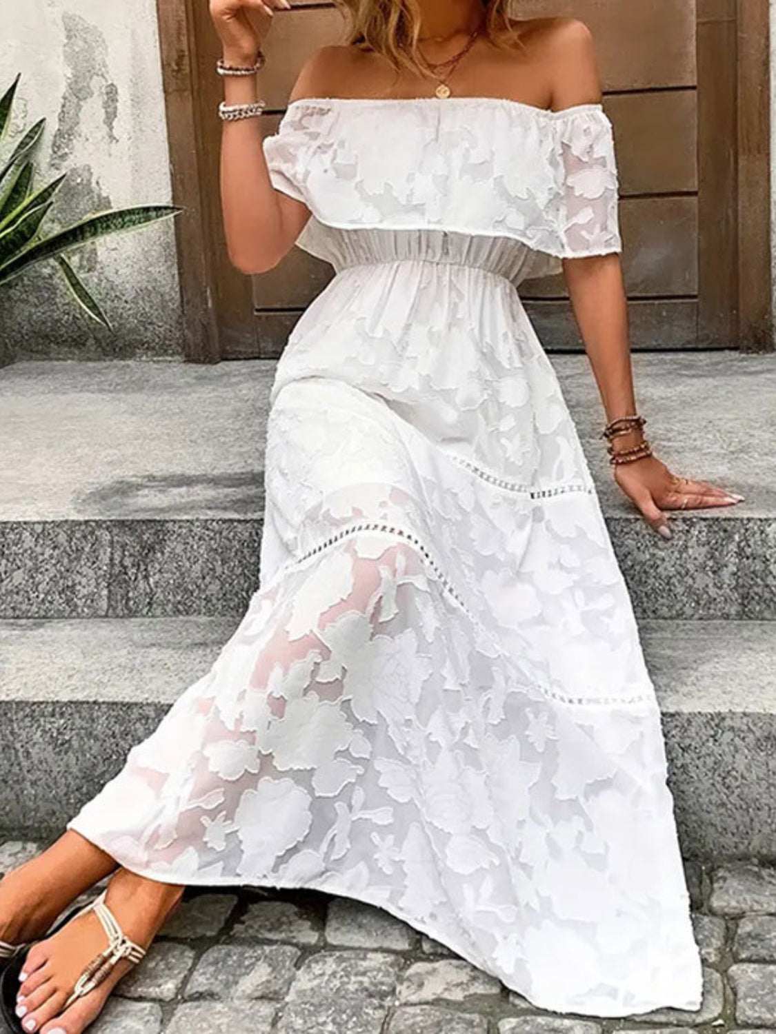 Off-shoulder white floral semi-sheer maxi dress with short sleeves.