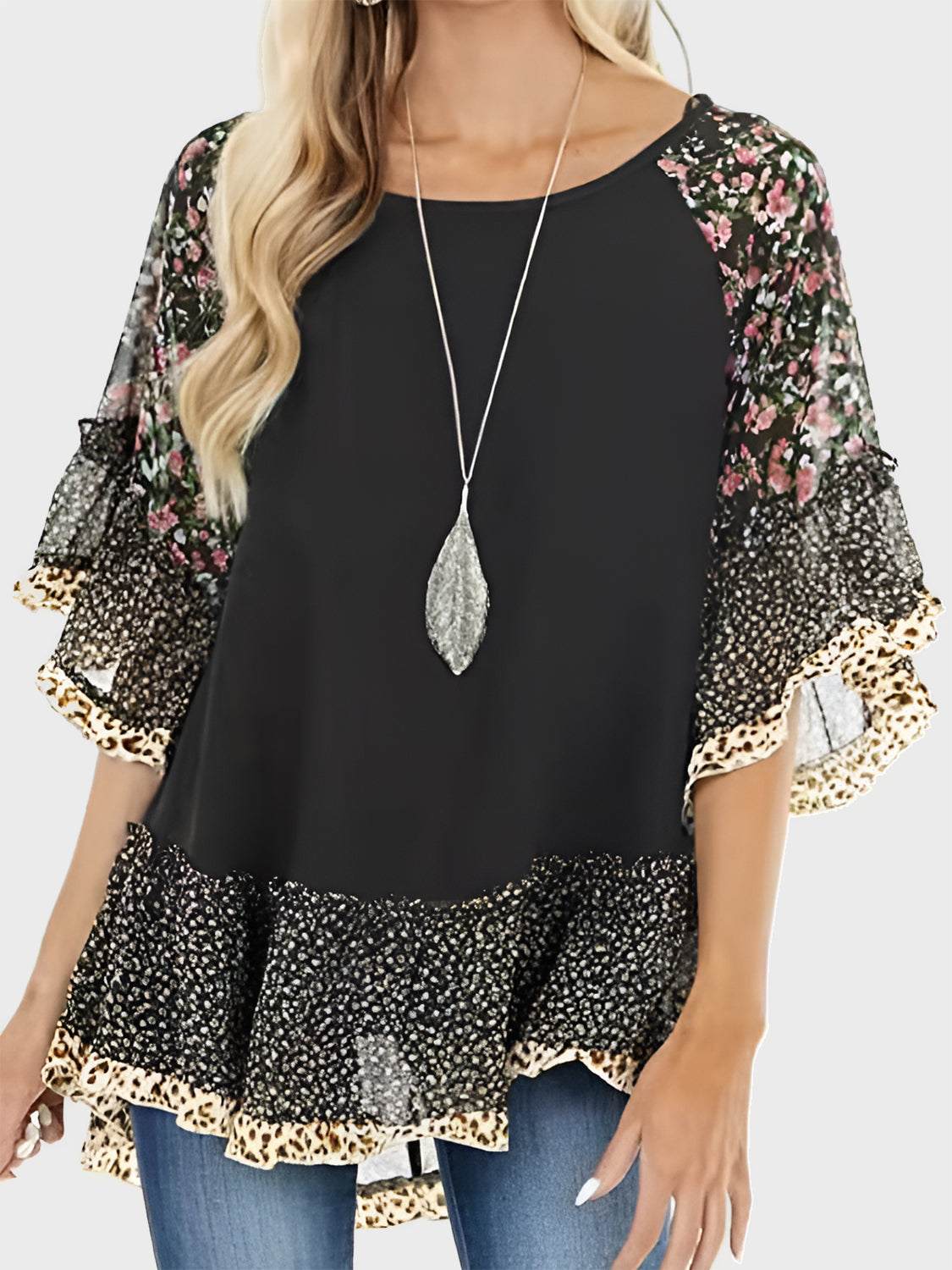 Full size frill printed round neck half sleeve blouse in black with floral pattern and layered hem.