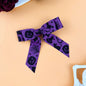 2-piece polyester bow hair clip, purple with black Halloween-themed designs, 4.3x3.9 inches.