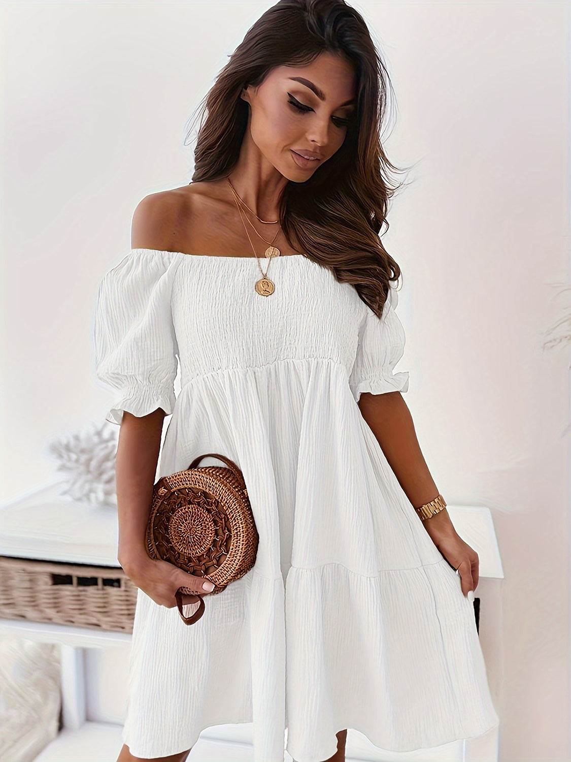 Ruffled off-shoulder short sleeve dress in white with ruched detailing.