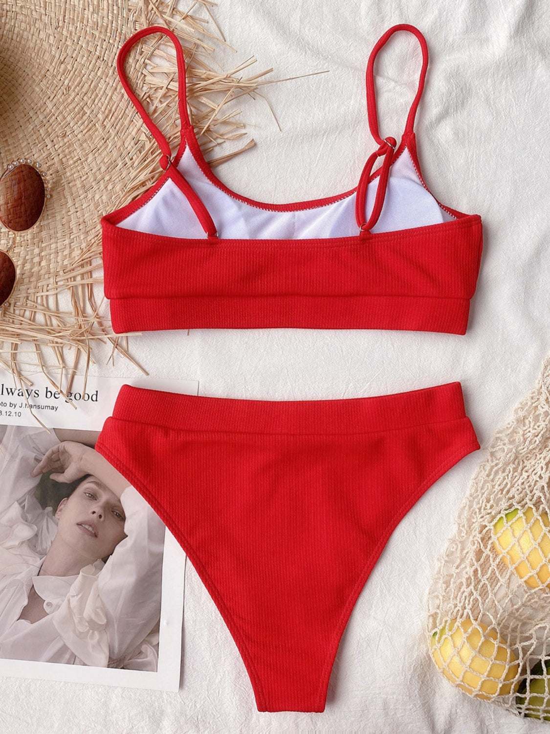 Scoop neck spaghetti strap two-piece swim set in red with removable padding and no underwire, made of polyester and spandex.