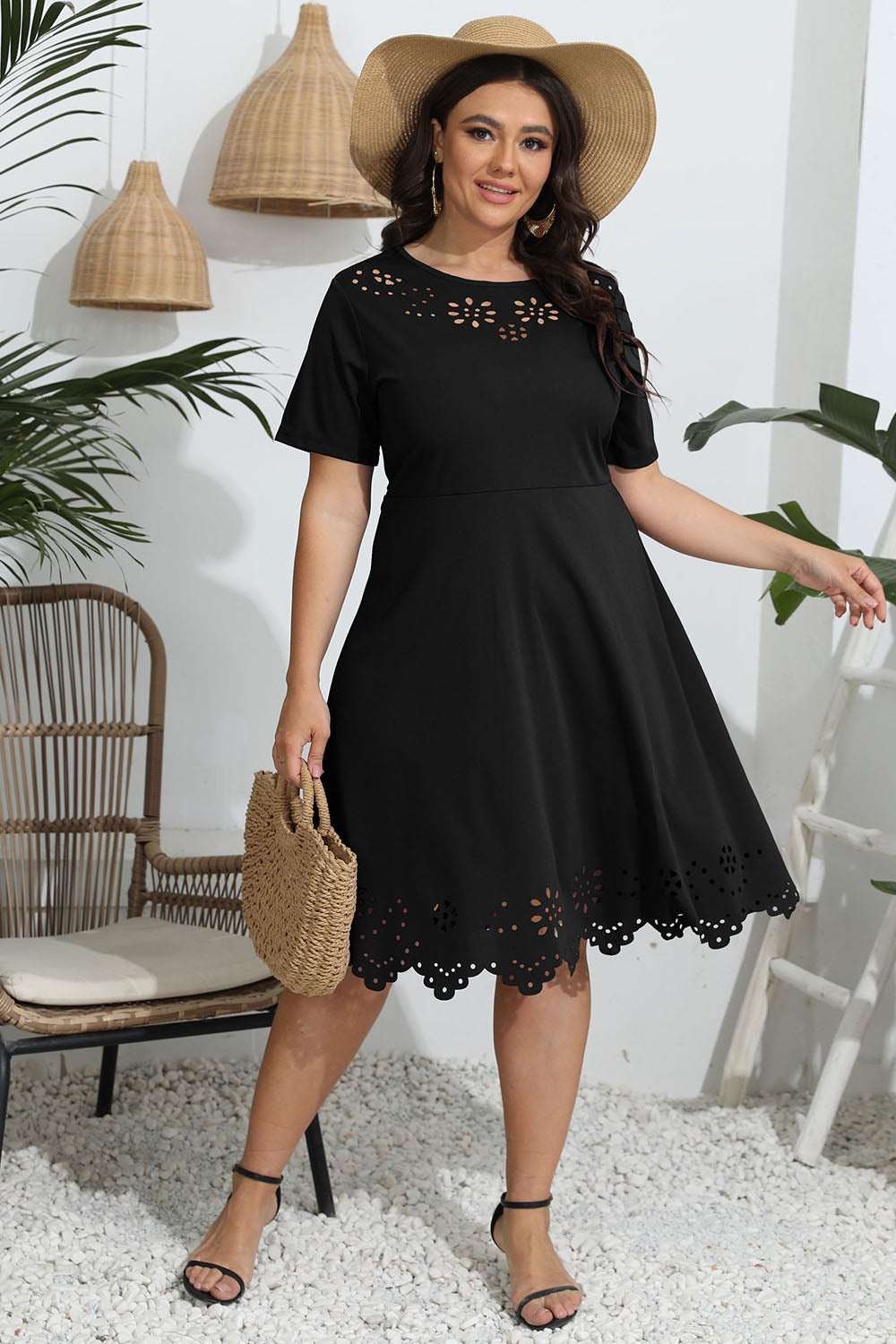 Plus size round neck openwork dress in black with short sleeves and scalloped hem.