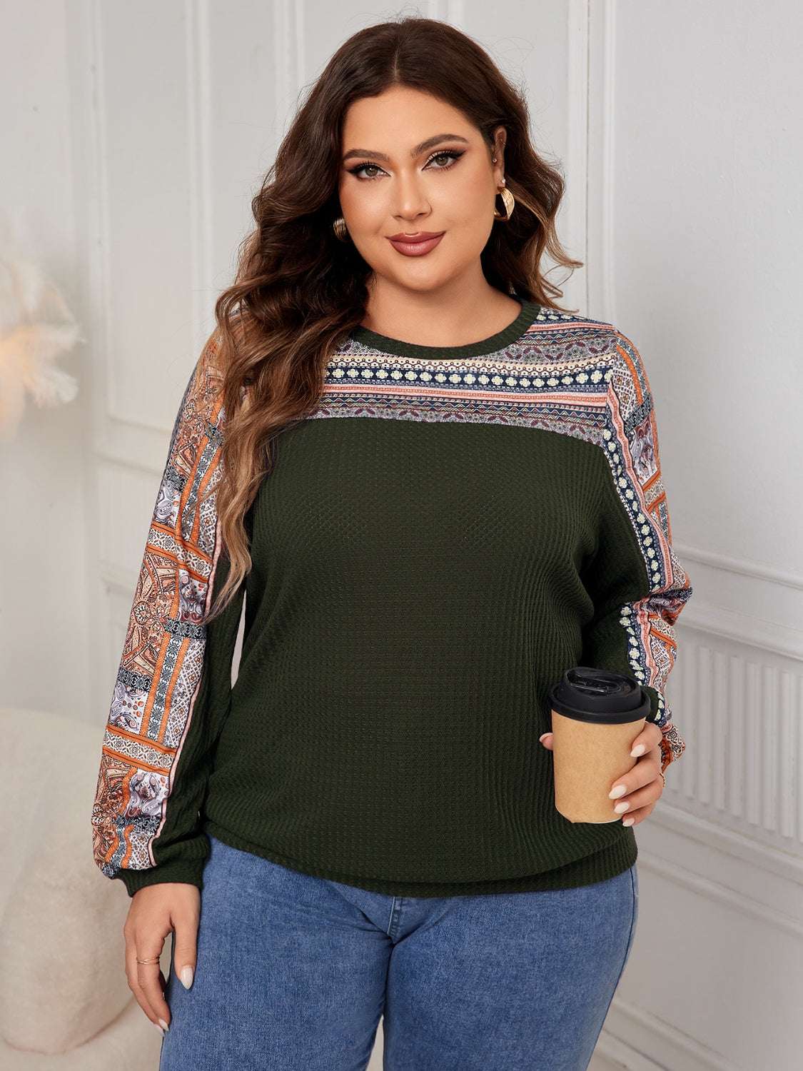 Plus size printed long sleeve sweatshirt in dark green with patterned shoulders and sleeves.