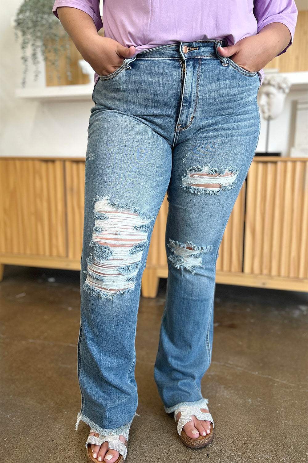 Judy Blue distressed raw hem bootcut jeans with edgy detailing and versatile style.